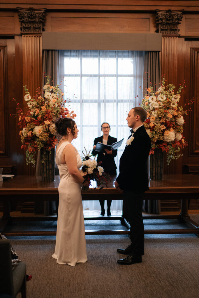 sharing vows during intimate ceremony in the westminster room at the old marylebone town hall 