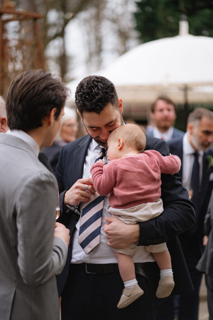 baby sleeping during drinks reception at baddow park house