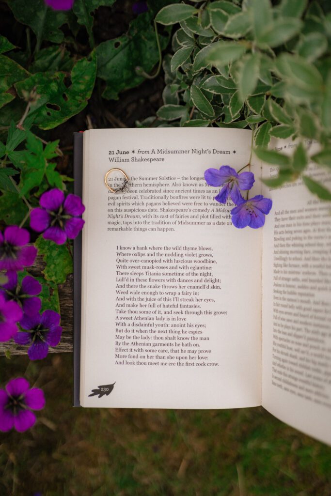 close up of wedding ring and book reciting a midsummer nights dream