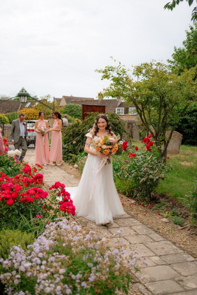 flora walking towards the church
