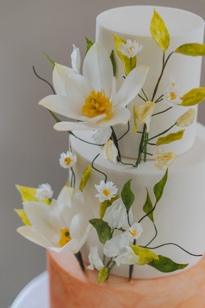 three tiered cake with sugar flowers