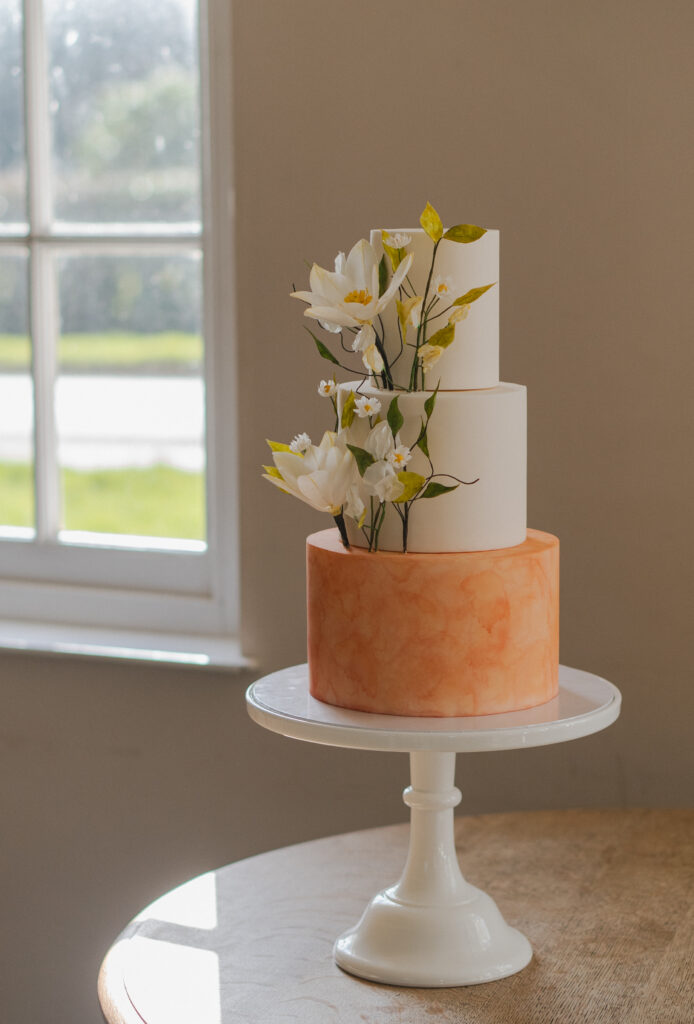 three tiered cake with sugar flowers