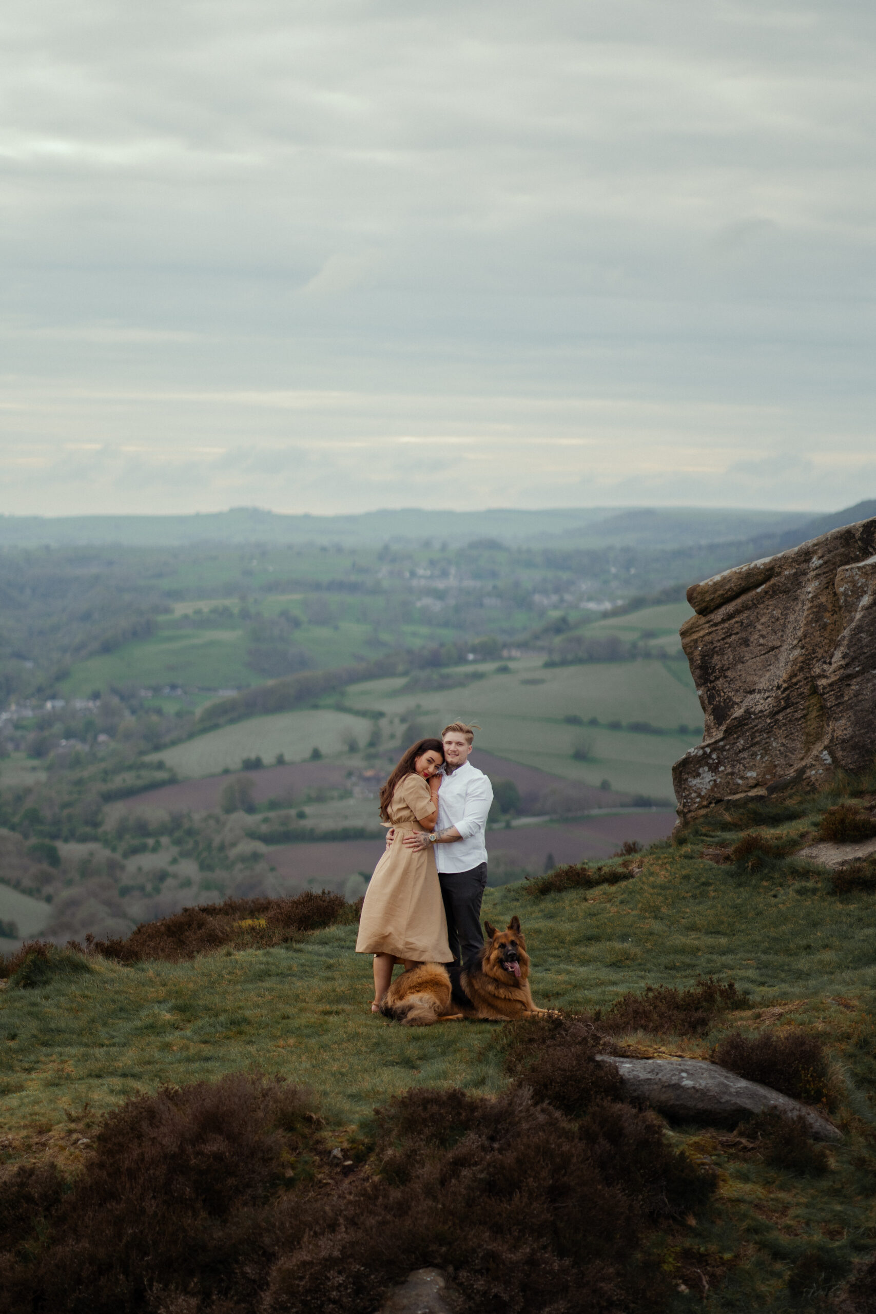 portrait of rosie and jake during their engagement photoshoot at curbar edge in the peak district