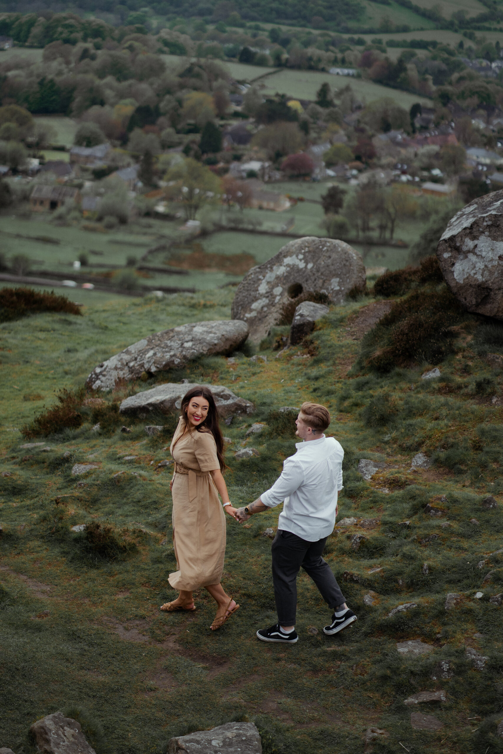 portrait of rosie and jake during their engagement photoshoot at curbar edge in the peak district