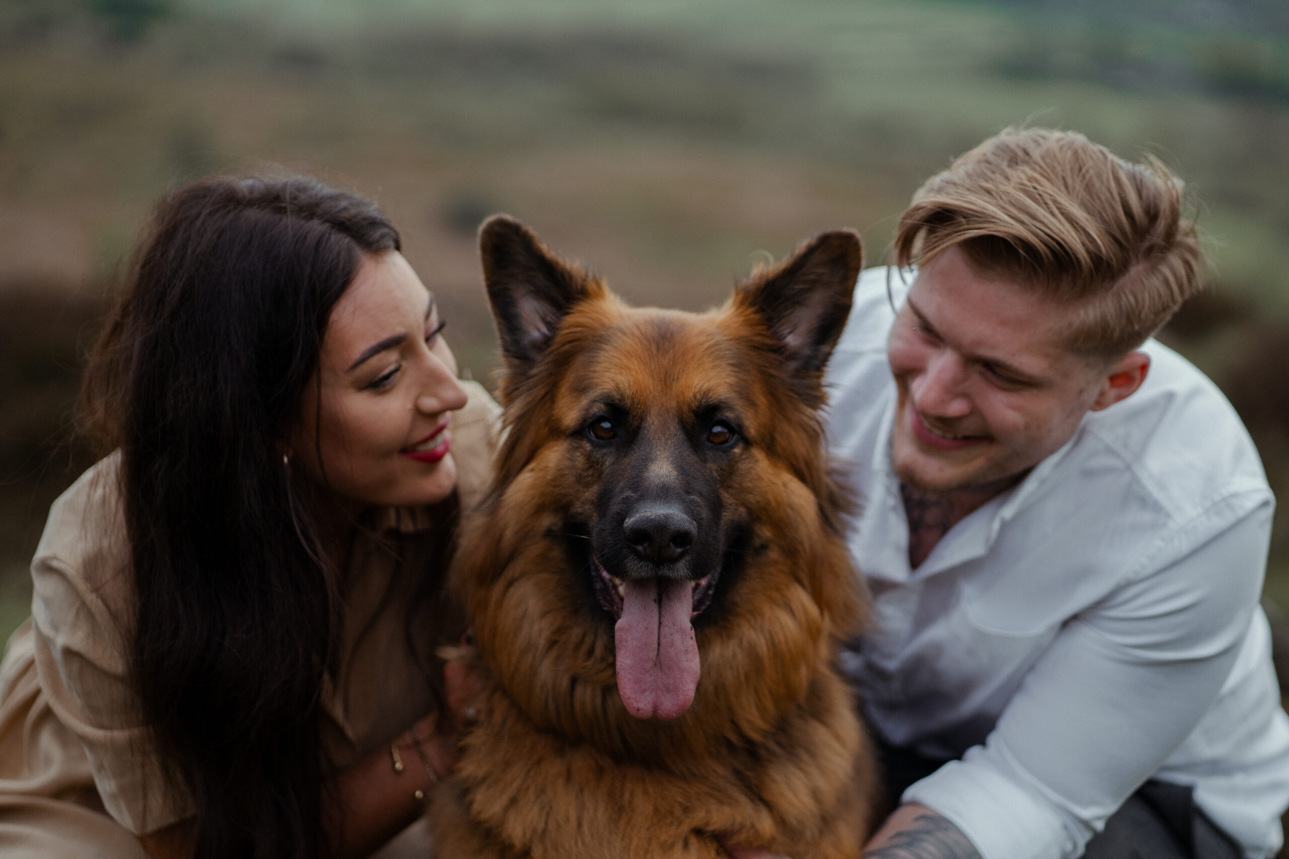 family portrait of rosie, jake and their dog Buddy during their engagement photoshoot at curbar edge in the peak district