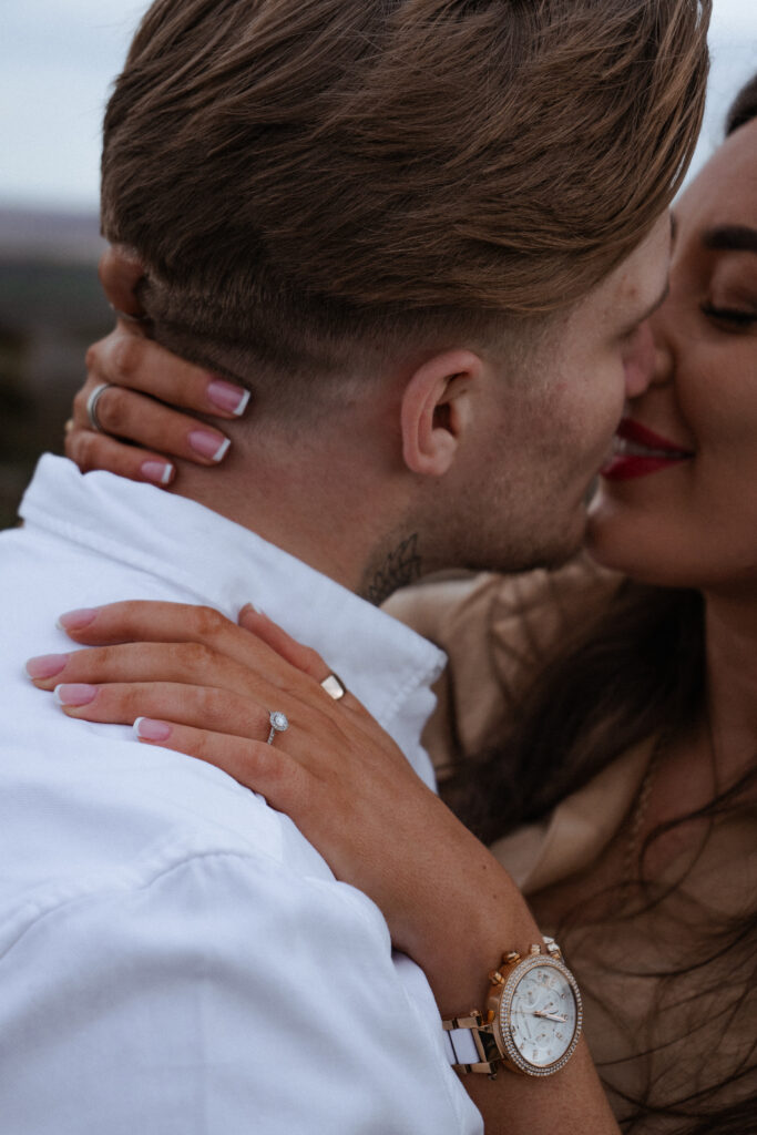 portrait of rosie and jake during their engagement photoshoot at curbar edge in the peak district