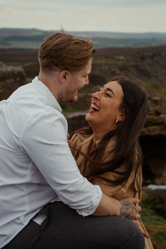 portrait of rosie, jake and buddy during their engagement photoshoot at curbar edge