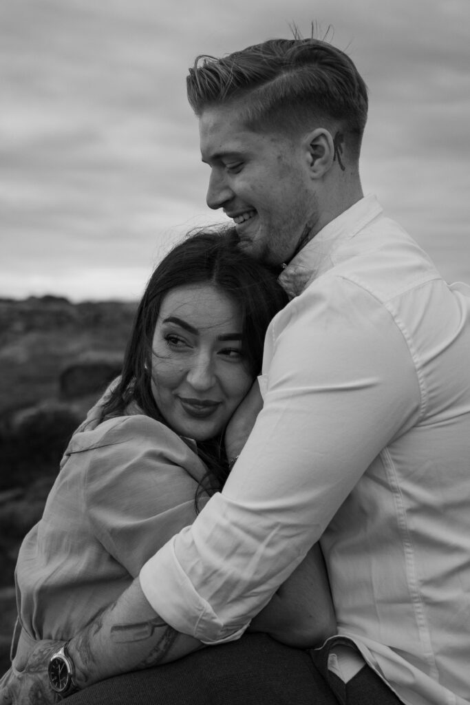 portrait of rosie and jake during their engagement photoshoot at curbar edge in the peak district