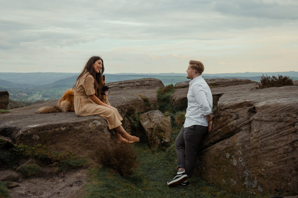 portrait of rosie, jake and buddy during their engagement photoshoot at curbar edge