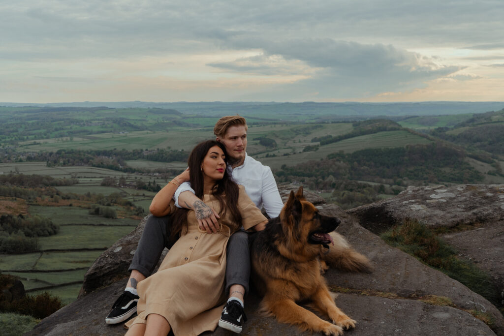 portrait of rosie, jake and buddy during their engagement photoshoot at curbar edge