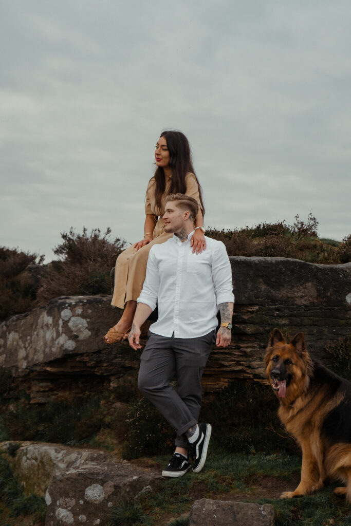 portrait of rosie, jake and buddy during their engagement photoshoot at curbar edge