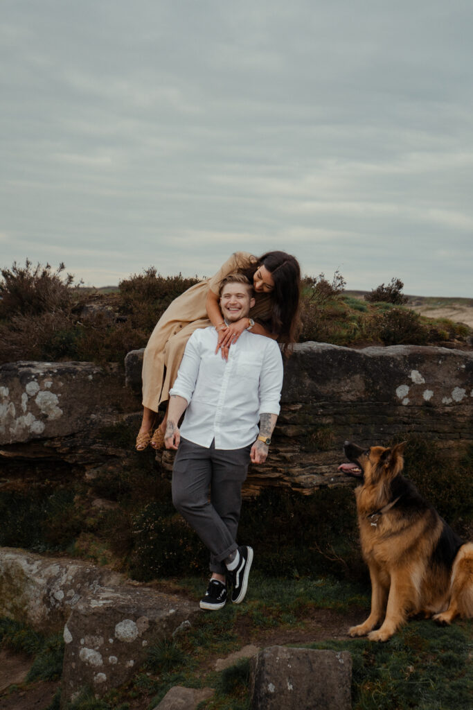 portrait of rosie, jake and buddy during their engagement photoshoot at curbar edge