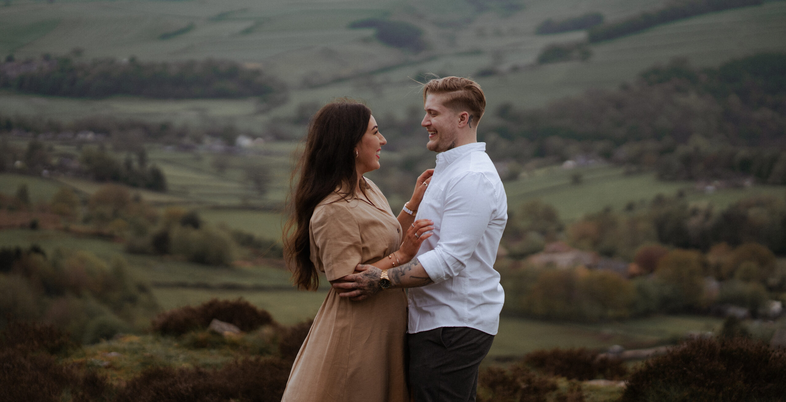 jake and rosie portrait during their engagement photoshoot at curbar edge, overlooking Hope Valley in the Peak District