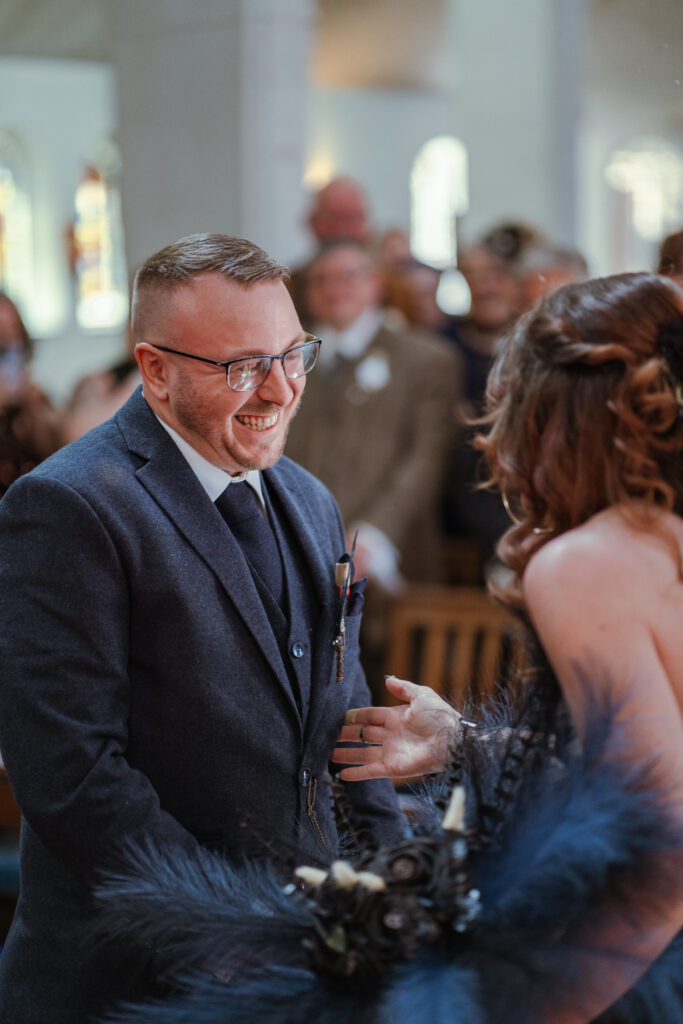 hugging groom at alter in st faiths church, lee-on-the-solent