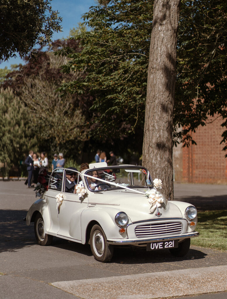 bride and groom leaving st faiths church, lee-on-the-solent in a morris minor