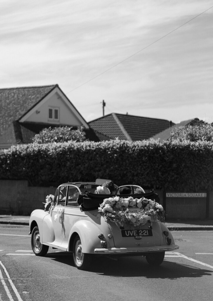 bride and groom leaving st faiths church, lee-on-the-solent in a morris minor