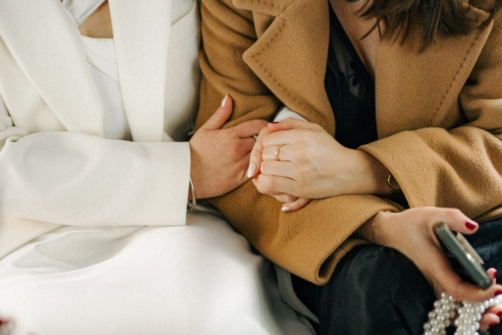 bride holding hands closeup with friends