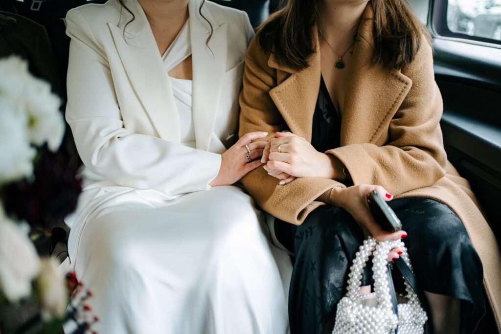 bride holding hands closeup with friends