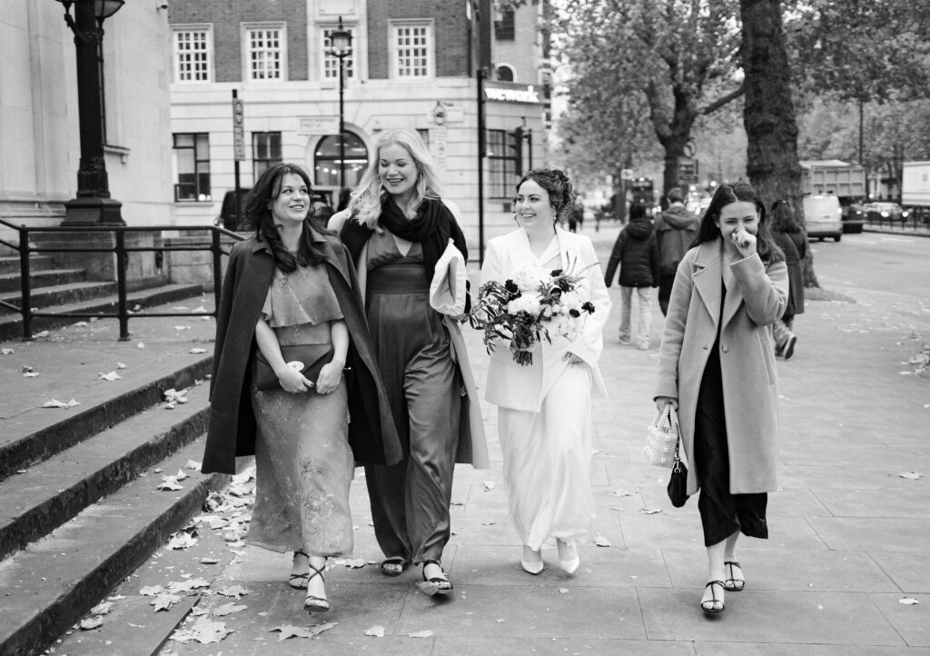 bride and three friends walking into old marylebone town hall