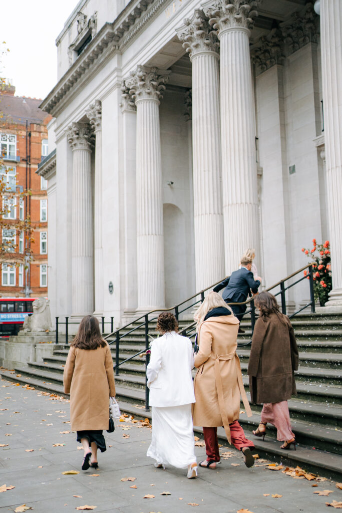 bride and three friends walking into old marylebone town hall