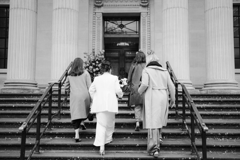 bride and three friends walking into old marylebone town hall