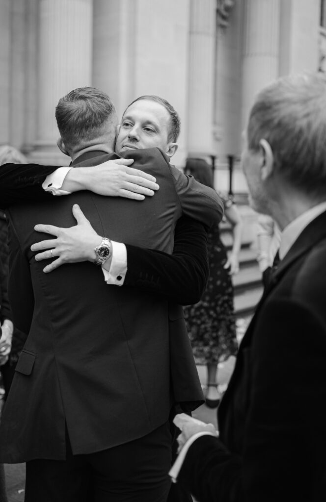 groom hugging guests