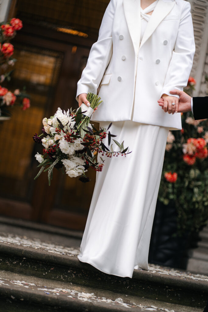 close up of brides dress and flowers 