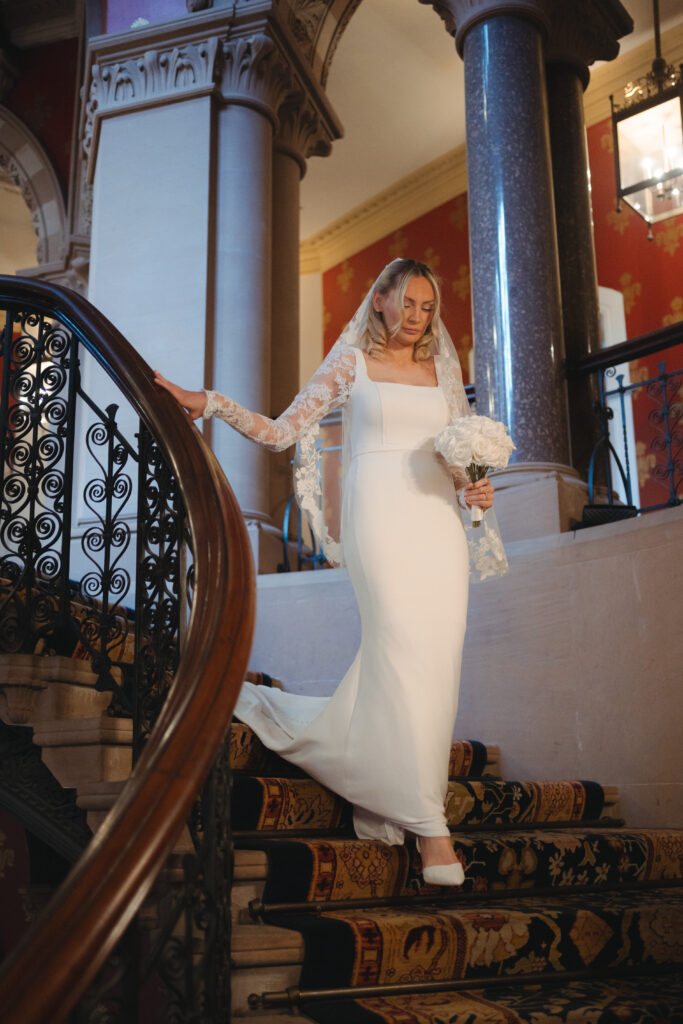 dayna walking down the grand staircase at St Pancras Renaissance Hotel 