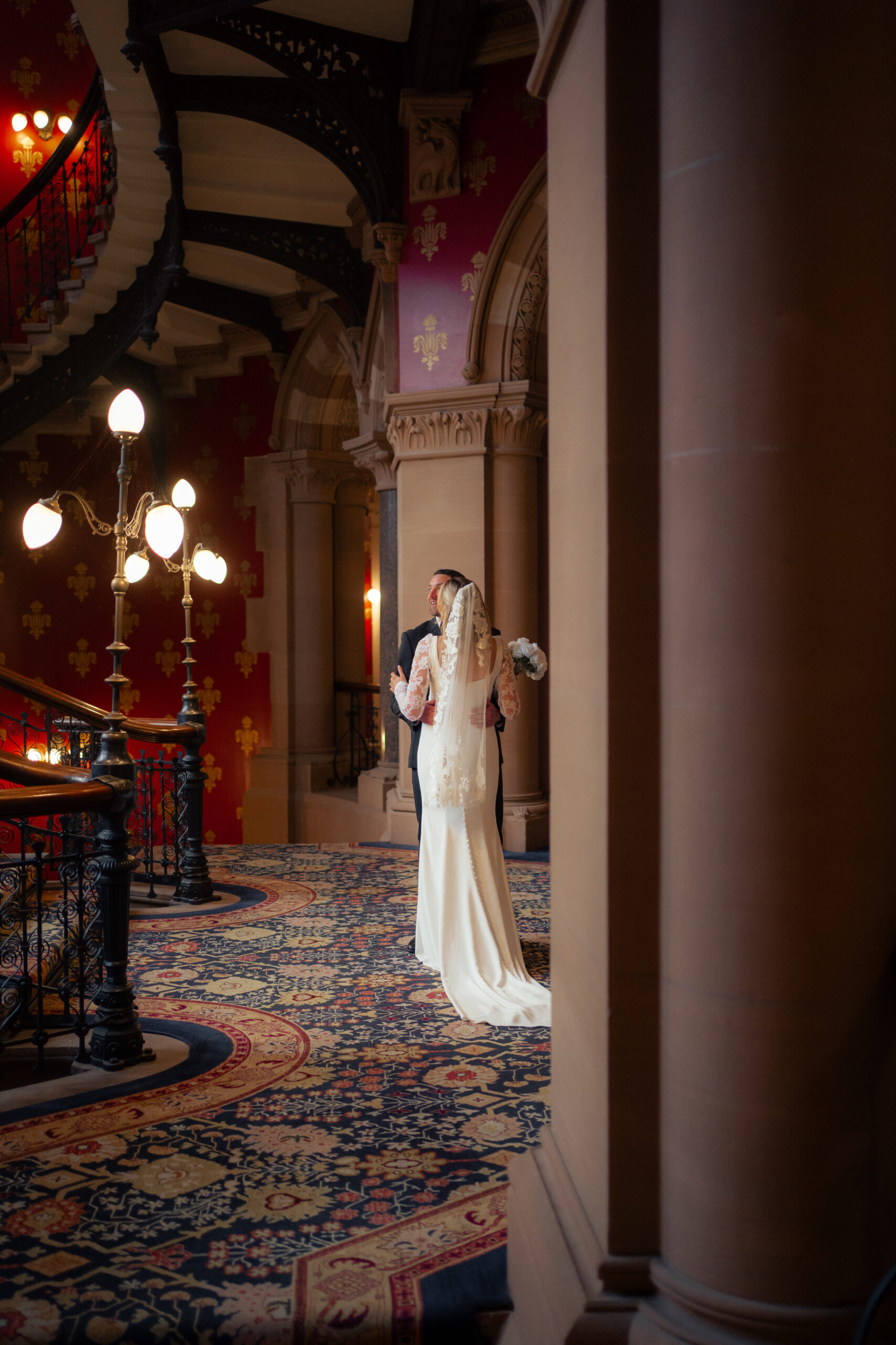 couple portraits on the grand staircase at St Pancras Renaissance Hotel 