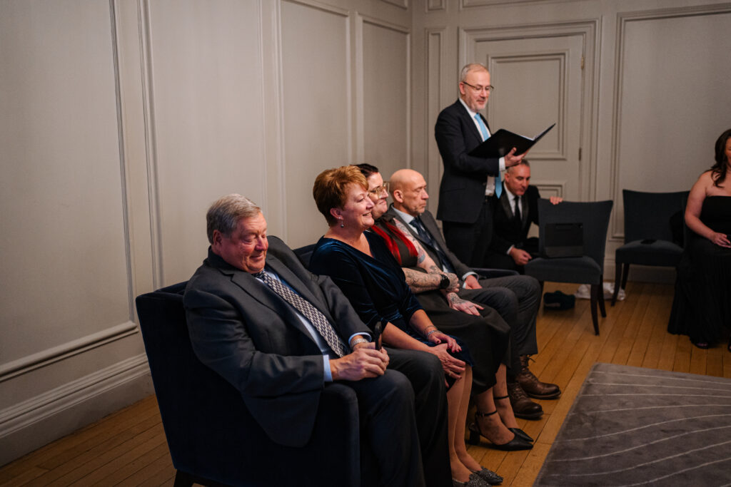 Guest reactions during elopement ceremony in the Soho Room at Old Marylebone Town Hall