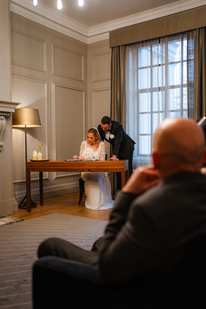 signing the register during elopement ceremony