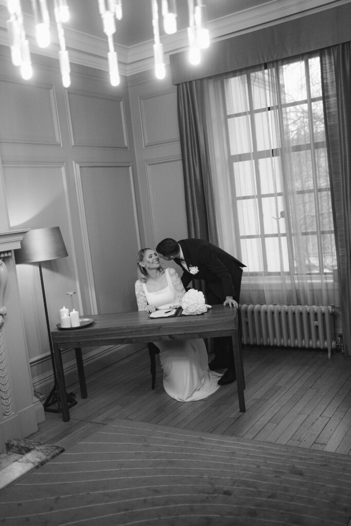 signing the register during elopement ceremony