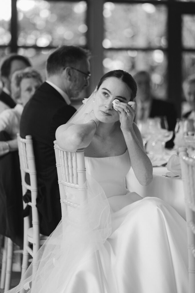 bride crying at speech during wedding breakfast at baddow park house
