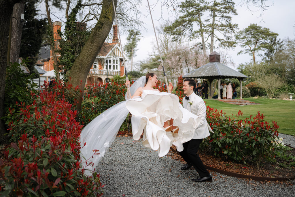 bride and groom portraits on swing at baddow park house during spring wedding